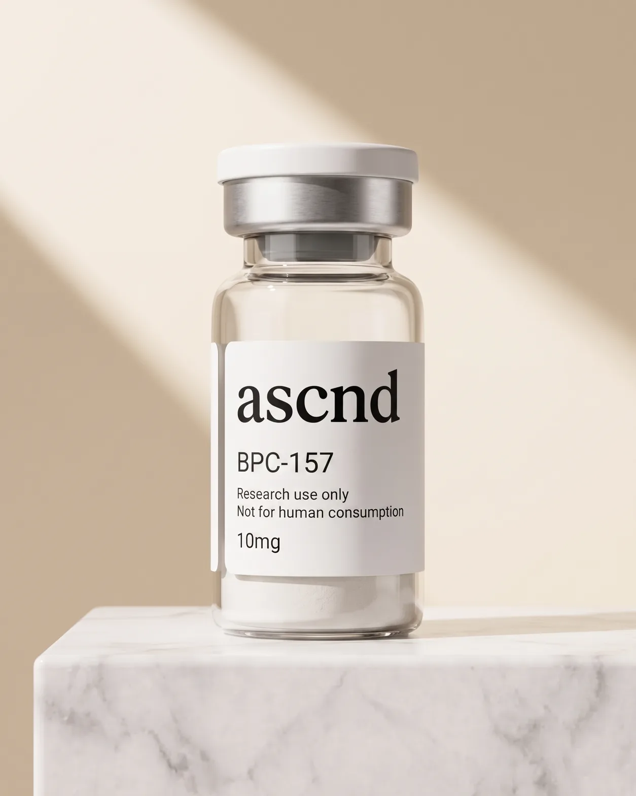 Clear glass ASCND vial of white lyophilized powder with a research-use-only label, on a marble plinth